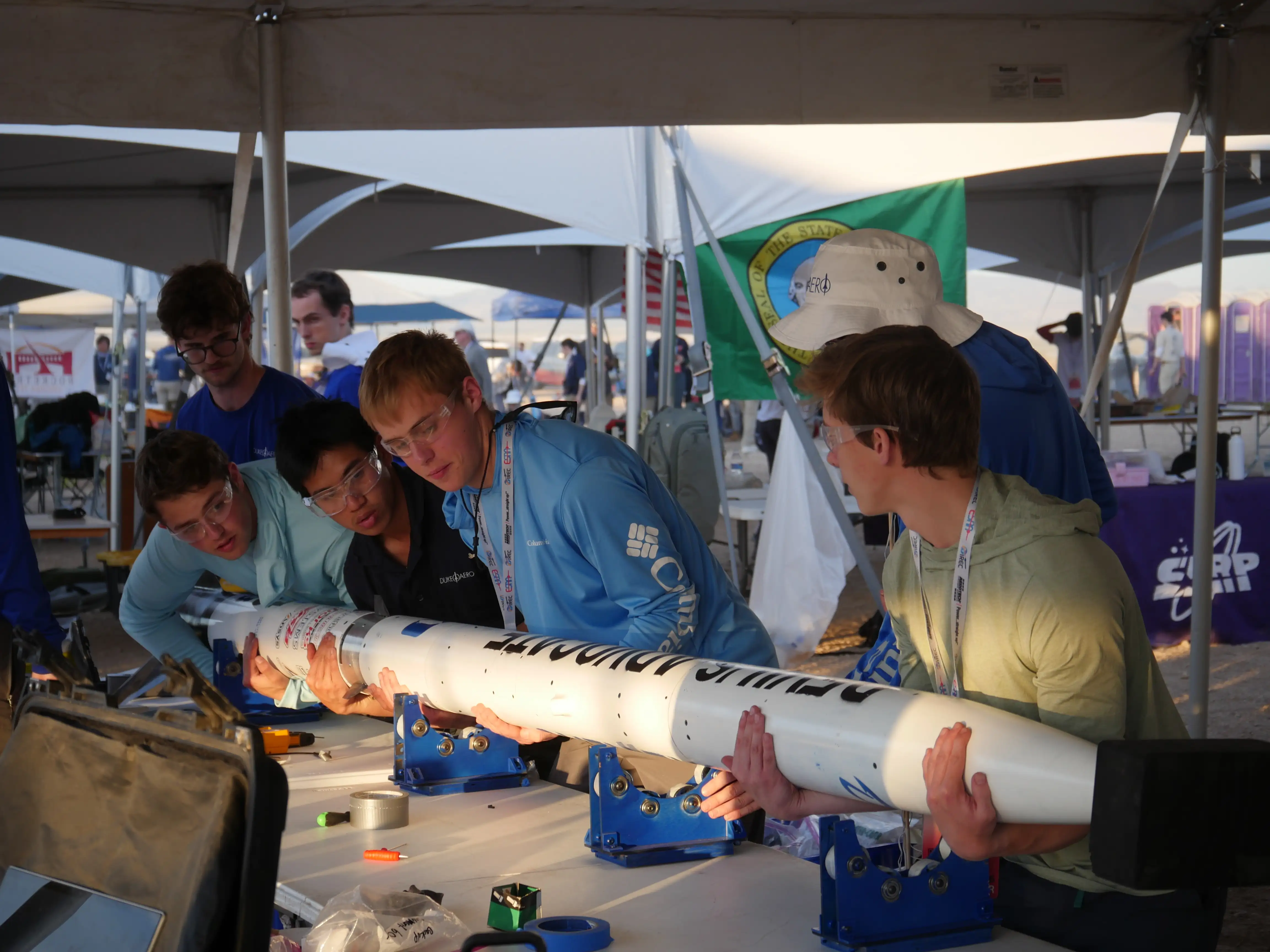 Multiple Team Members Carrying Rocket
